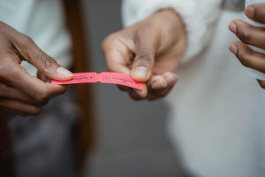 Crop unrecognizable African American friends holding small paper tickets in hands on street in daytime
