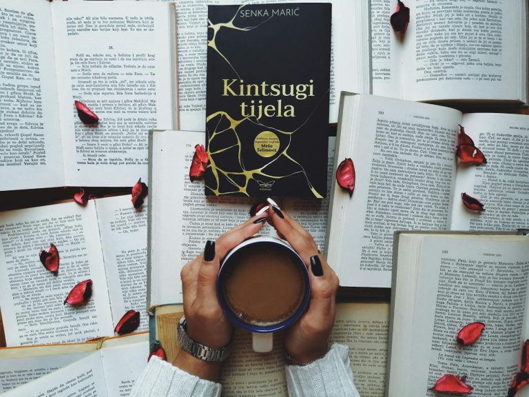 A serene scene featuring a book, cup of coffee, and scattered rose petals, perfect for relaxation themes.
