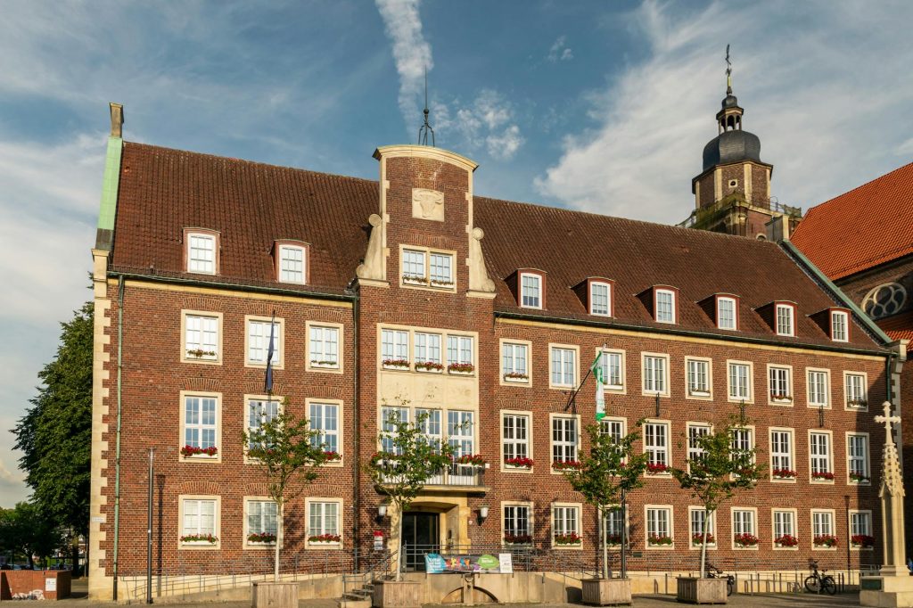 A historic town hall building with classic architecture basking in the vibrant sunlight outdoors.