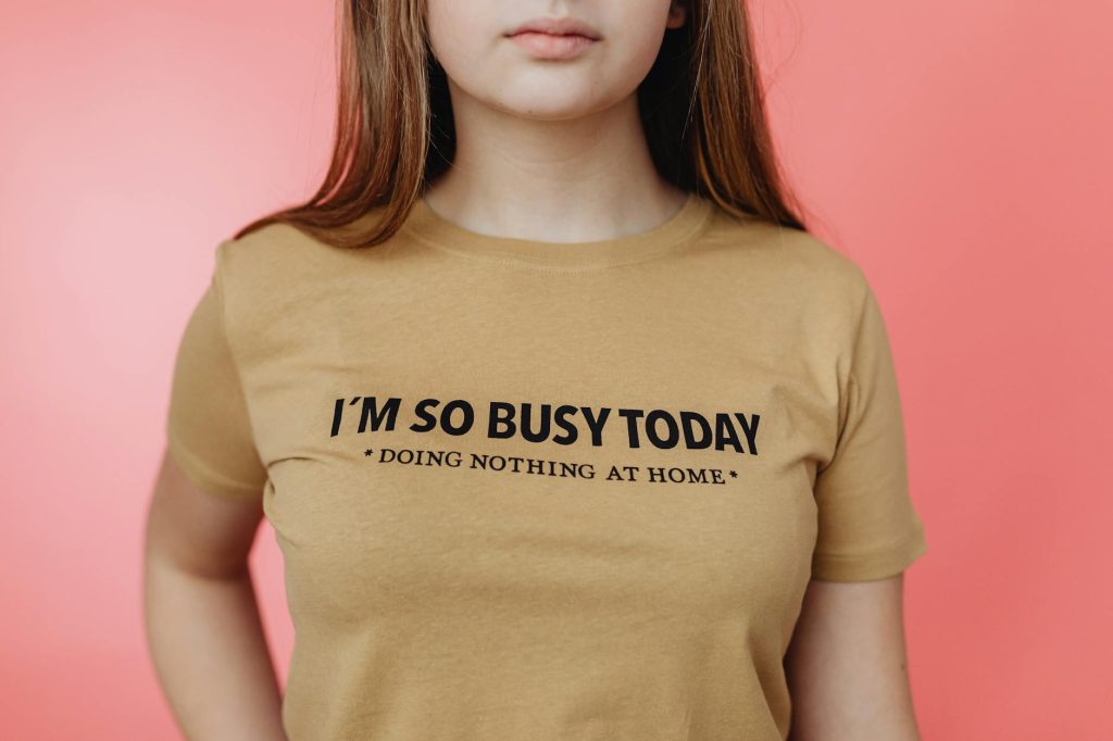 Close-up of a woman wearing a humorous t-shirt with the text 'I'm so busy today.'
