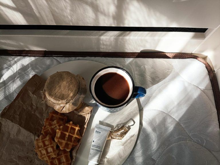 A cozy morning breakfast scene with coffee, waffles, and sunlight creating a serene atmosphere.