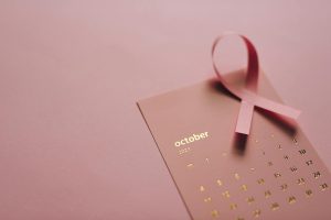 Pink ribbon on October 2021 calendar symbolizing breast cancer awareness.
