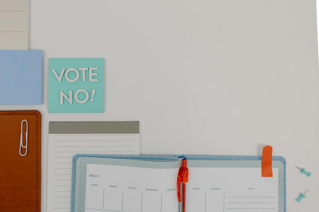 Creative flat lay with a notepad and 'Vote No' message. Ideal for organizational or political concepts.