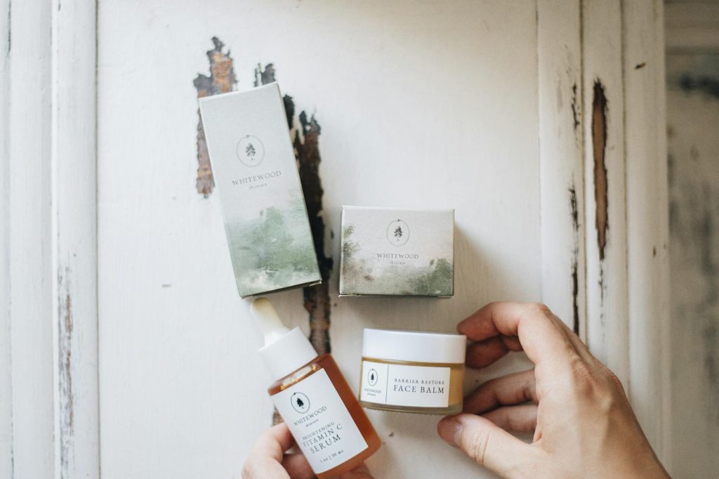 High-angle view of natural skincare products featuring face serum and balm with eco-friendly packaging.