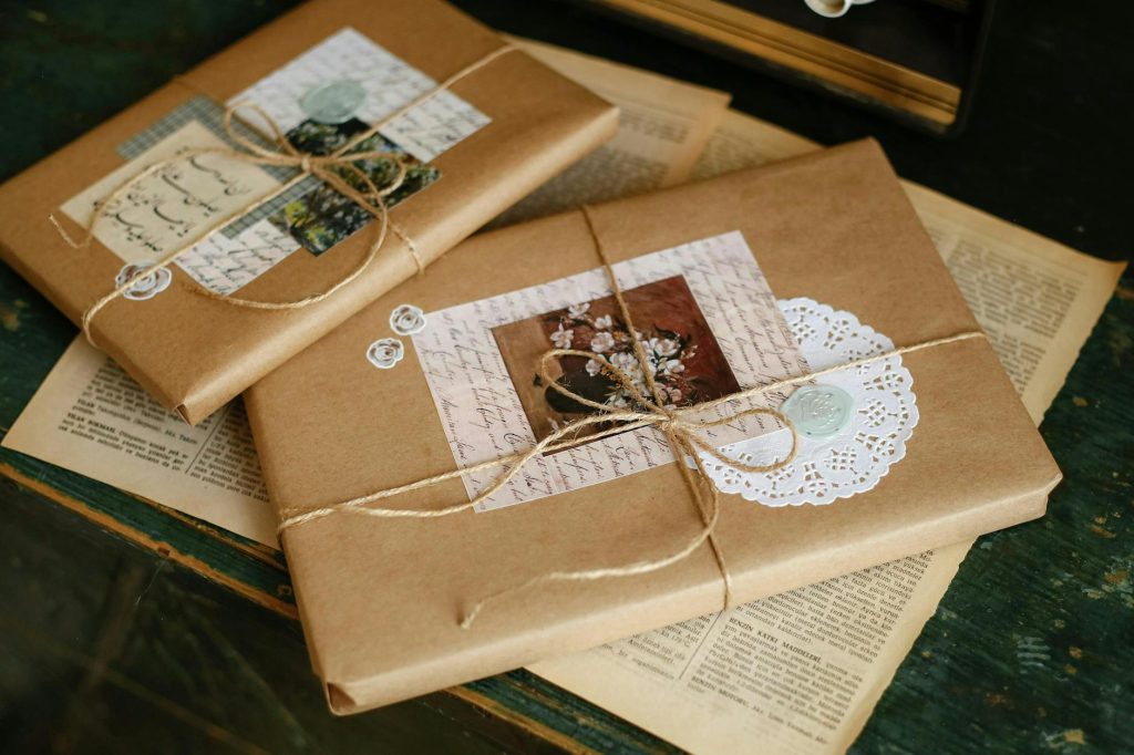 Beautifully wrapped gifts in kraft paper with vintage accents and twine.
