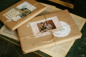 Beautifully wrapped vintage gift packages with decorative elements on a wooden table.