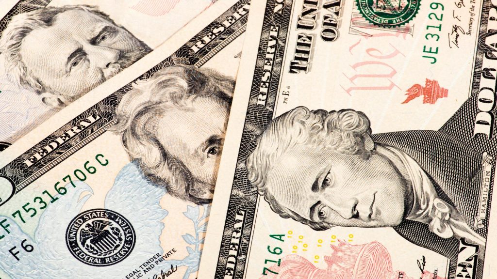 Detailed close-up shot of US dollar bills showing various denominations.