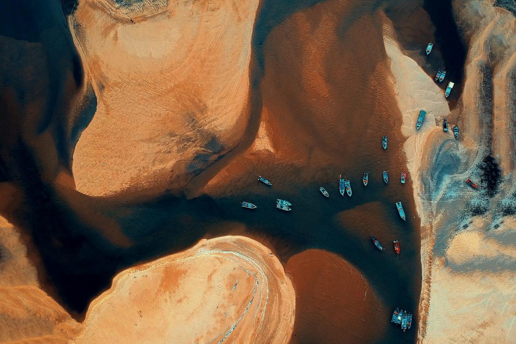 Stunning aerial view of vibrant boats on Kemasik river, Malaysia. Ideal for travel visuals.
