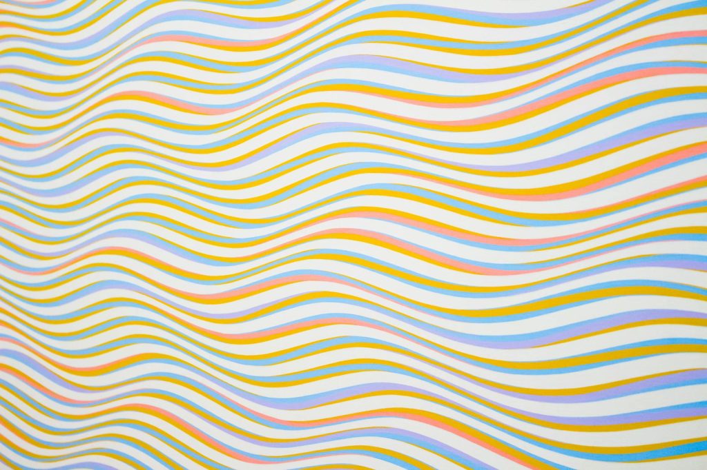 Colorful wavy lines creating an abstract and vibrant background pattern.