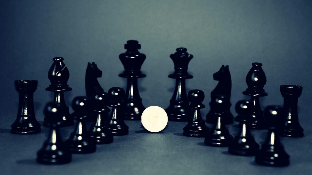 Elegant black chess pieces strategically displayed, creating a moody and strategic atmosphere.