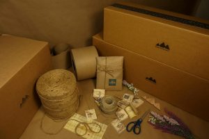 Explore a variety of eco-friendly packaging materials including boxes, kraft paper, and twine for sustainable shipping solutions.