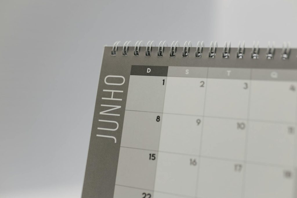 Close-up view of a spiral-bound calendar showing the month of June with a date grid.