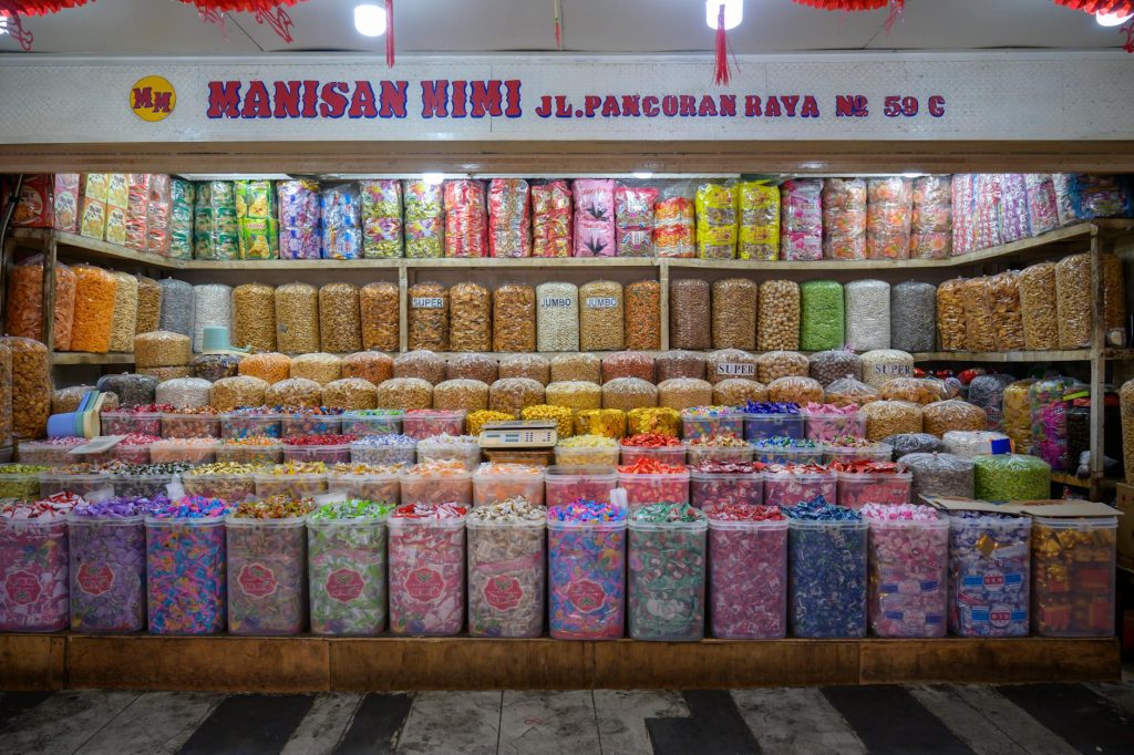 A vibrant display of assorted candies at Manisan Mimi, Jakarta, Indonesia, showcasing colorful local treats.