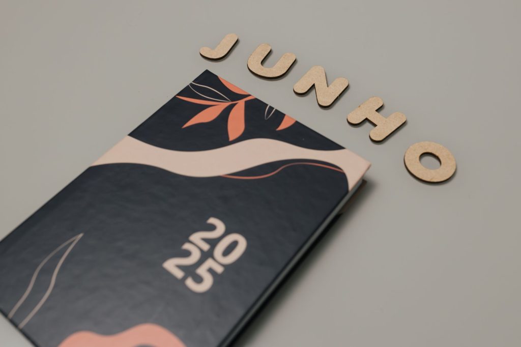 Stylish 2025 planner with abstract leaf patterns and 'JUNHO' letters on a minimalist background.